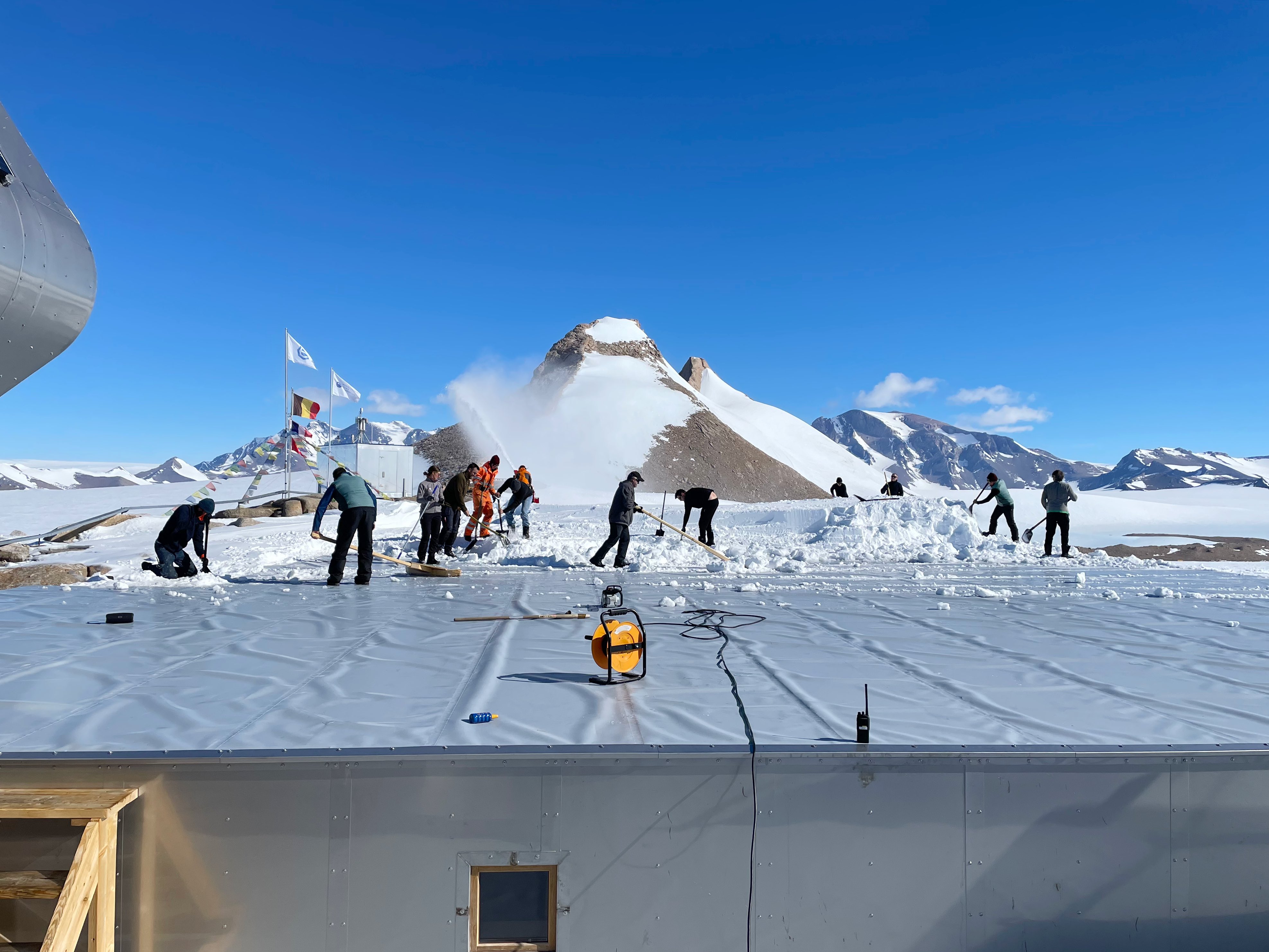 BELARE tema members remove snow from PEA roof